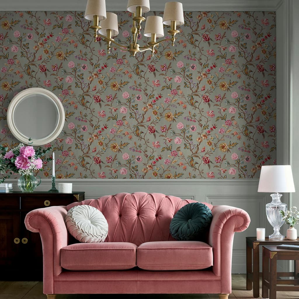 Laura Ashley Lingmell Trail Antique Green Wallpaper on a living room wall with a pink settee and wood sideboard.